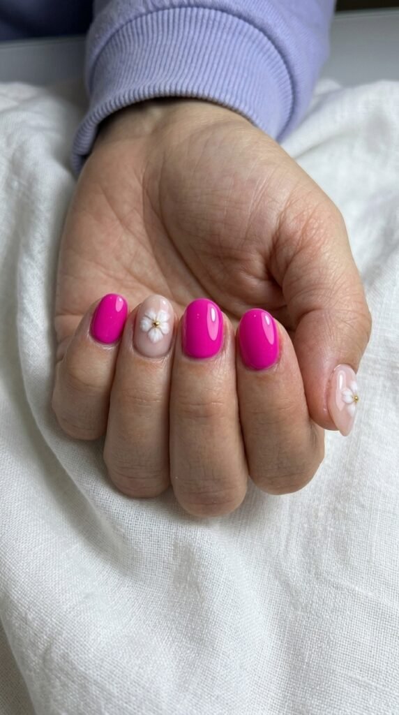 Bright pink sakura flower accent nails with glossy finish for summer 2026