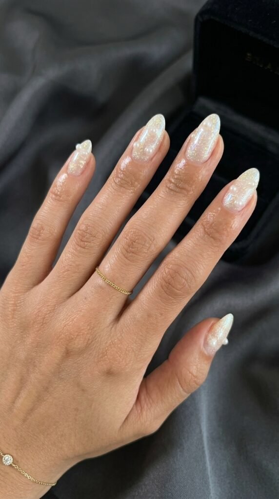 Coquette nail art with bows and pearls for fall nail trends 2026 with pastel and burgundy accents