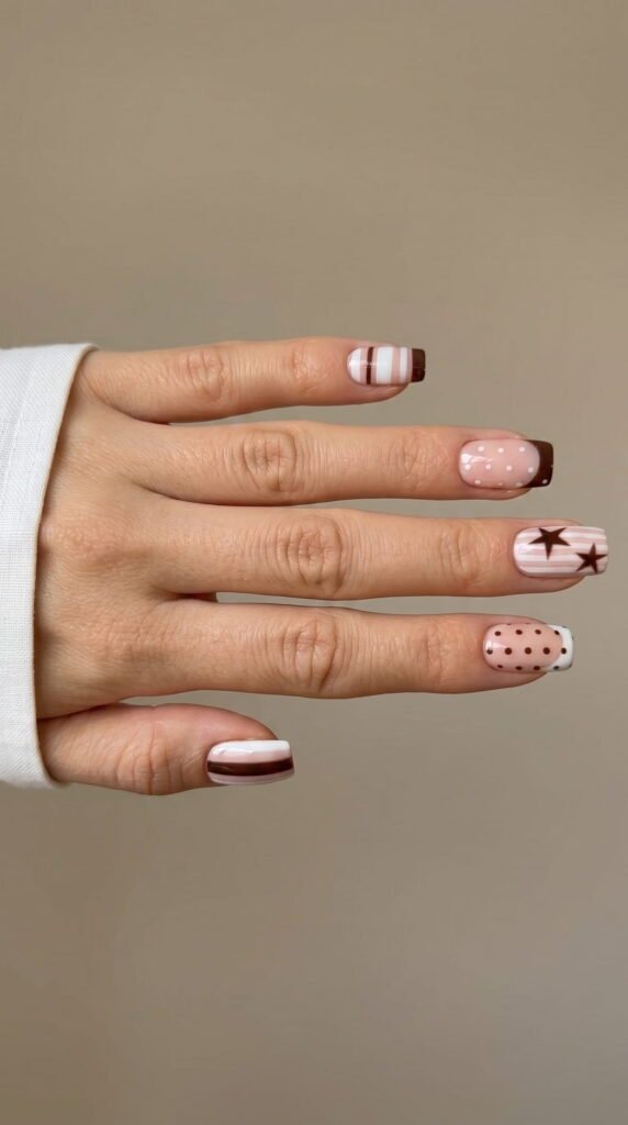 Square nails with mixed pink and brown polka dot, stripe, and star nail art