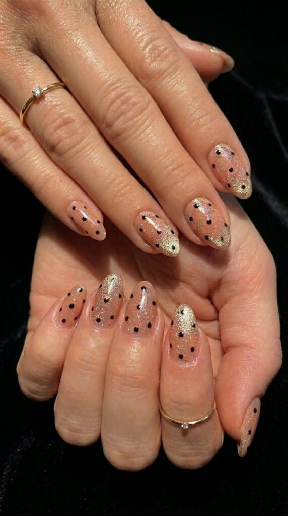 Moody velvet polka dot manicure for fall nail trends 2026 with burgundy and gold accents