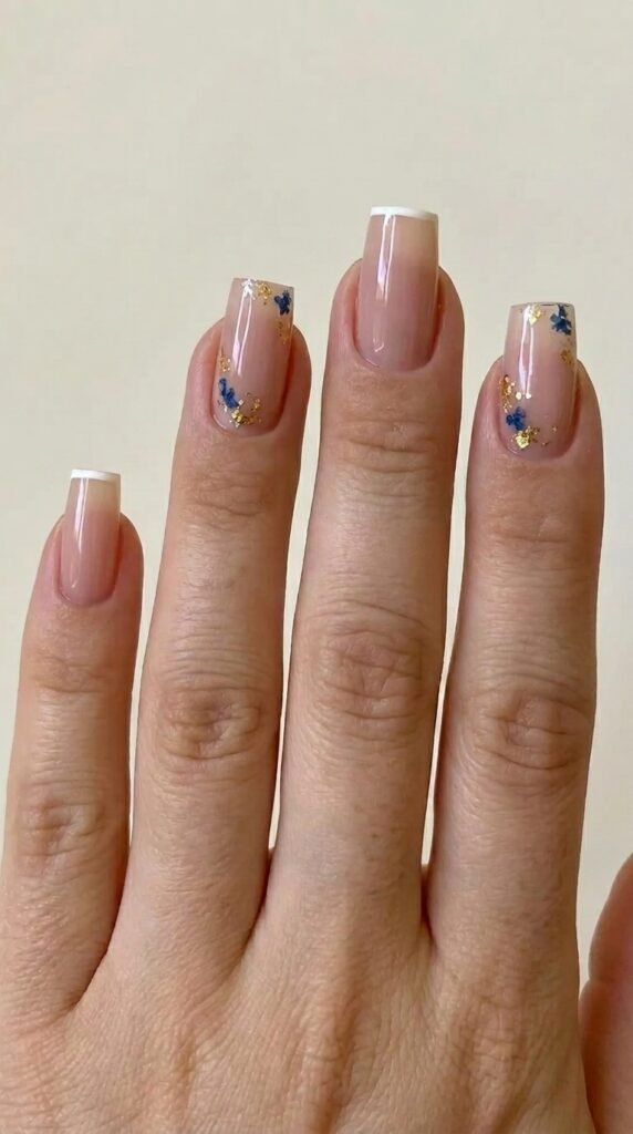 Pink French tips with blue florals and gold leaf gel nails – chic summer gel nail ideas artistic