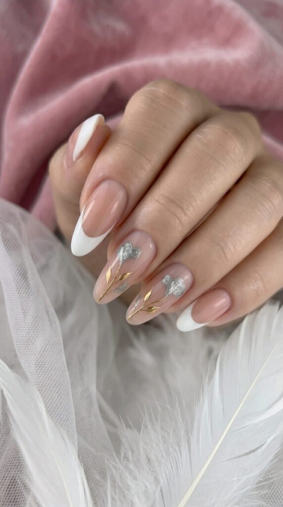 Long oval nails with soft pink French tips and silver floral nail art accent