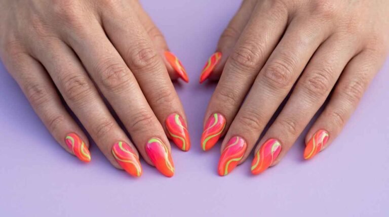 Woman's hands showing summer nail ideas for 2026 with neon coral, swirl designs, glossy gradients and gold charms
